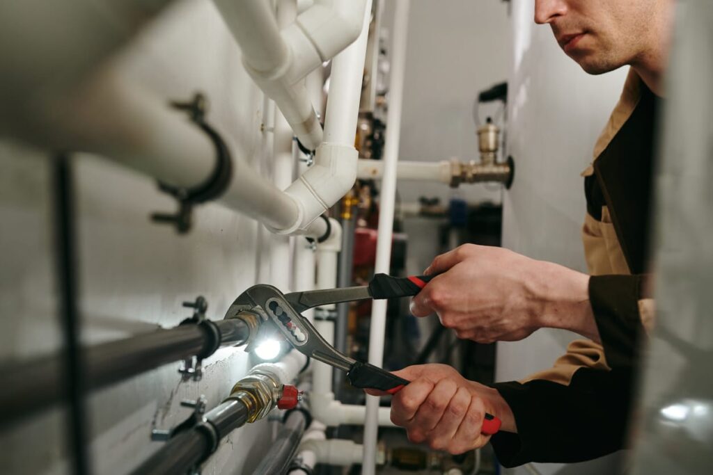Plumbers maintaining commercial plumbing pipes in Palm City