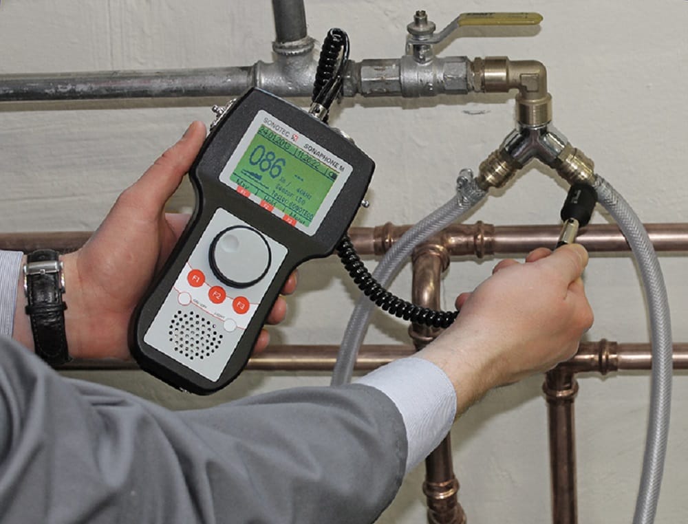 Plumber testing pipes with electronic leak detection equipment in Palm City