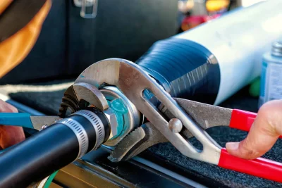 Technician tightening an industrial pipe connection in Palm City