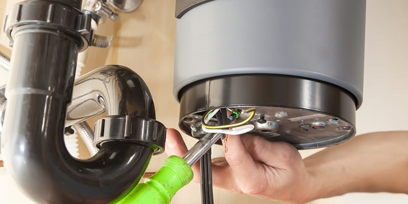 Technician repairing the heating element of a water heater in Palm City