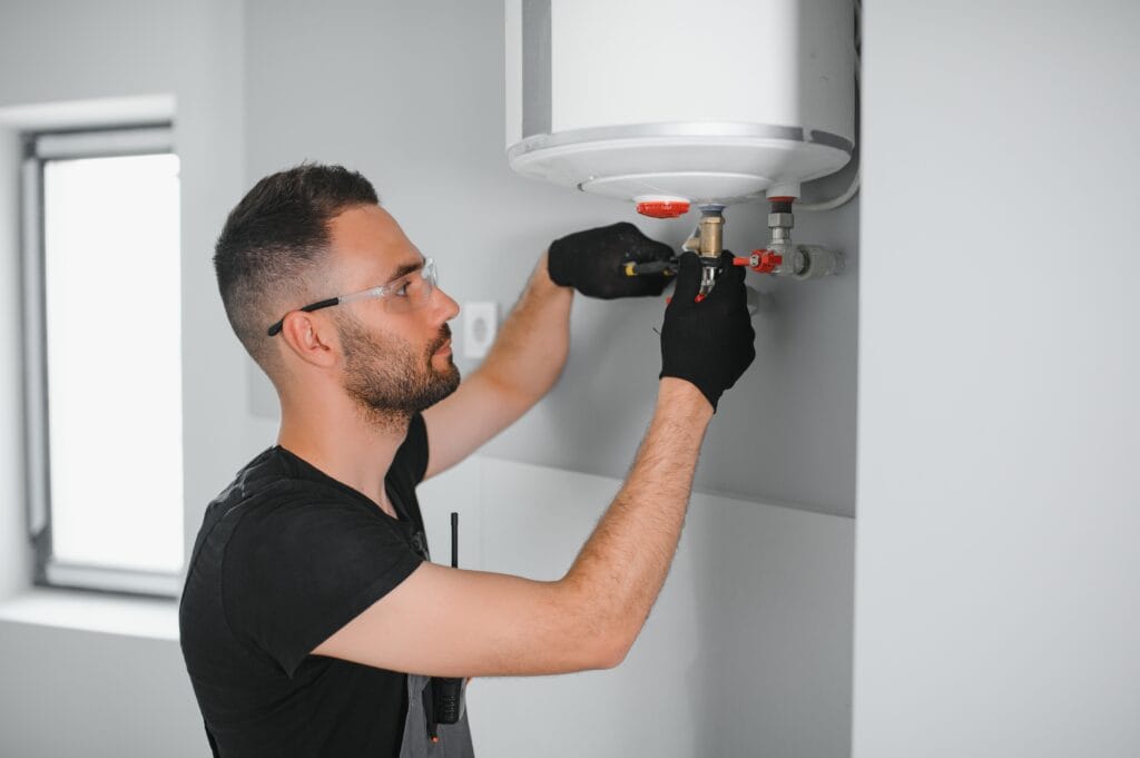 Technician performing water heater maintenance in Palm City